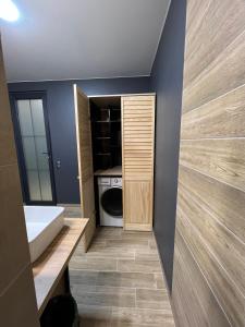 a bathroom with a sink and a washing machine at Cristal Apartament in Tiraspol