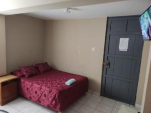 Hospedaje San Camilo Tacna tesisinde bir odada yatak veya yataklar