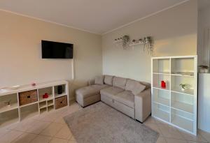 a living room with a couch and a flat screen tv at Over the Sky Apartment - Bologna in Bologna