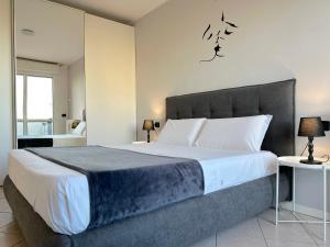 a bedroom with a large bed in a room at Over the Sky Apartment - Bologna in Bologna