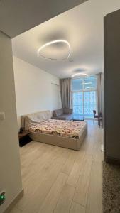 a bedroom with a bed and a large window at studio apartment 60 sqm skyline veiw in Dubai