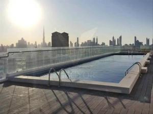 a large swimming pool on top of a building at studio apartment 60 sqm skyline veiw in Dubai