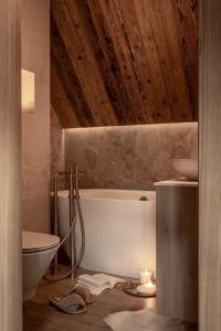 a bathroom with a tub and a toilet and a sink at Chalet V11 by Villa 11 Folk & Design in Zakopane
