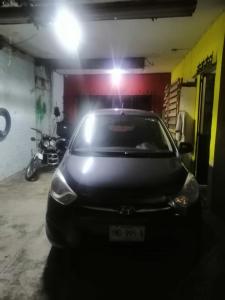 a car parked in a garage with a light on it at Casa céntrica antigua completa in Orizaba