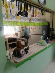 a kitchen with a counter with utensils on it at Casa céntrica antigua completa in Orizaba