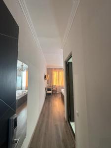 a hallway leading to a room with a bed and a mirror at Bina N28 in Kutaisi