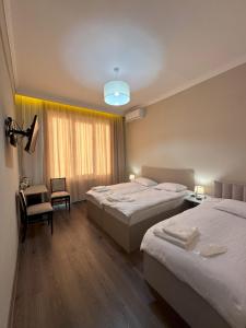 a hotel room with two beds and a window at Bina N28 in Kutaisi