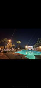 a large swimming pool at night with lights at Hypnotic Villa Pitesti in Piteşti