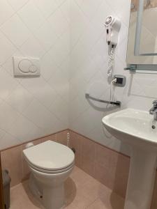 a bathroom with a toilet and a sink at Airport Hotel in Fiumicino +24 photos