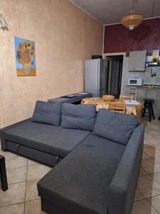 a living room with a couch and a kitchen at I GIRASOLI in Turin