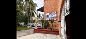 a building with a sign on the side of a street at Paulas Suites in Ixtapa