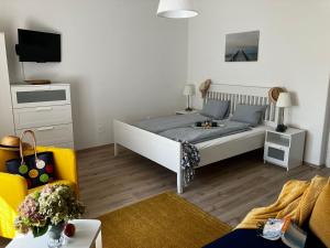 a bedroom with a bed and a living room at Tündér Villa in Balatonfüred