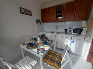 a small kitchen with a table with dishes on it at Zagreb apartment Toni in Zagreb