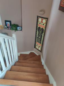 a stairway with a painting on the wall at La Villa Bleue in Beauchastel +8 photos