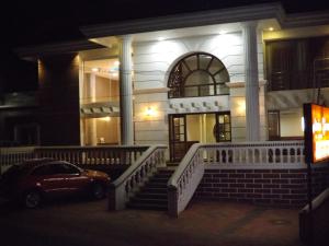 a car parked in front of a building at night at The Majestic Crown in Ooty