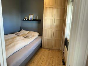 a small bedroom with a bed and wooden floors at Breathtaking Scenery and Cozy Comfort in Bergen in Bergen