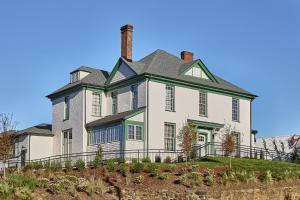 a large white house with a green roof at Zelda Dearest in Asheville