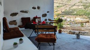 a dining room with a table and chairs with a view at Casa Carlota in Hermigua