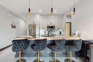 a kitchen with a counter with four bar stools at Riverfront Paradise in Melbourne