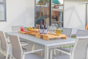 a table with two bottles of wine and glasses at New Luxury Home with Games Room and Park Outlook Sleeps 12, 26 mins from CHC airport in Lincoln
