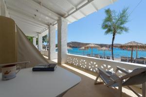 une chambre avec une table et des chaises et la plage dans l'établissement Emily Hotel, à Vári