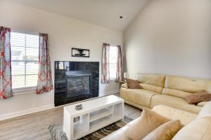 a living room with a couch and a fireplace at Cape Charles Home 4 Mi to Kiptopeke State Park! in Cape Charles