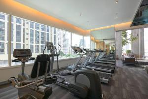 a gym with a bunch of treadmills in a building at Expansive Modern - BTS Phrom Phong - Ultra Fast WiFi in Khlong Toei
