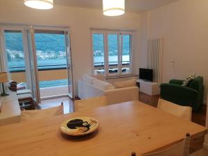a living room with a table and a living room with a view at Lakefront 15 in Omegna +18 photos