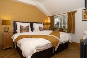 a bedroom with a large bed and a window at The Brasenose Arms in Banbury