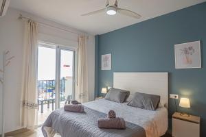 a bedroom with a bed with two towels on it at Apartamentos Chimenea in Nerja