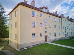 an exterior view of a large yellow building at revLIVING Apartment Quintus Baden City Center in Baden