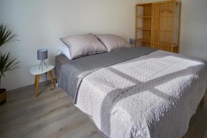 a bedroom with a bed and a night stand at revLIVING Apartment Quintus Baden City Center in Baden