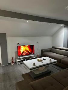 a living room with a couch and a fireplace at Vila Bate Bole 