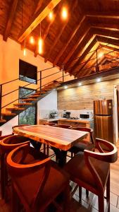 a large kitchen with a wooden table and chairs at Cabaña Luna Encantada in Mazamitla