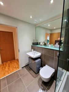 a bathroom with a toilet and a sink at Amazing flat in the heart of Manchester city centre! in Manchester
