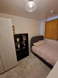 a bedroom with a bed and a dresser at Amazing flat in the heart of Manchester city centre! in Manchester