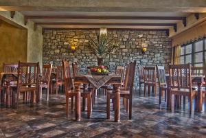 a dining room with a table and chairs at Hotel Doupiani House in Kalabaka