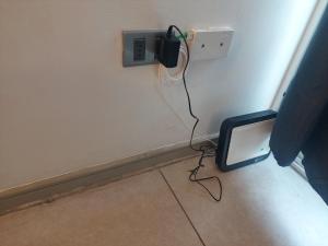 a phone plugged into a outlet in a wall at MATIZ CAVANCHA in Iquique