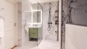 a bathroom with a shower and a sink at Villa Maija 2 Southside in Hanko