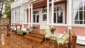 a porch of a house with a table and chairs at Villa Maija 2 Southside in Hanko