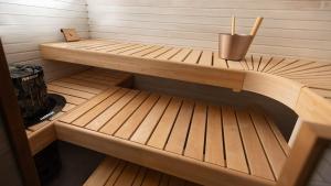 a small sauna with a wooden bench in it at Villa Maija 2 Southside in Hanko