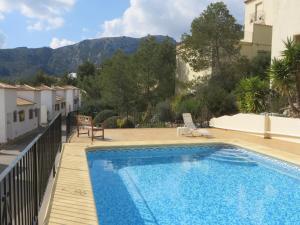 a swimming pool in a villa with mountains in the background at *Casa Anna L'Atzubia in Adsubia