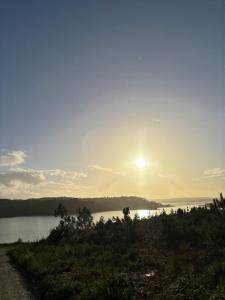 a sun setting over a body of water at The Genius of Genius in Saint-Denis-lès-Bourg