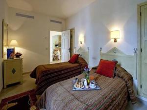 a hotel room with two beds and a tray of food at Diar Lemdina Hotel in Hammamet