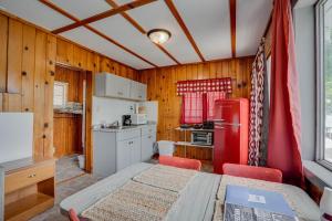 a kitchen with a red refrigerator and white cabinets at Lakeshore Cabin 5 on the Lake in Lake Ozark