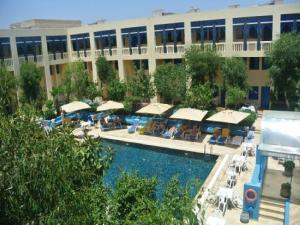 a hotel with a swimming pool and a building at Diar Lemdina Hotel in Hammamet