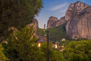 a street light with a view of the mountains at Hotel Doupiani House in Kalabaka