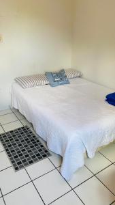 a bed sitting on a tiled floor in a room at Edifício Ocean garden in São Luís