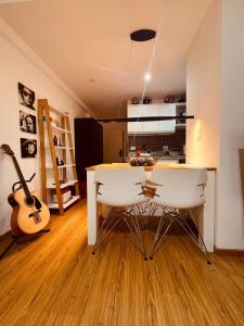 uma cozinha com uma mesa com duas cadeiras e uma guitarra em Palermo Studio AROZ2323-1A em Buenos Aires