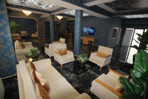 a lobby with couches and chairs and a television at Safir Hotels Çorlu in Corlu